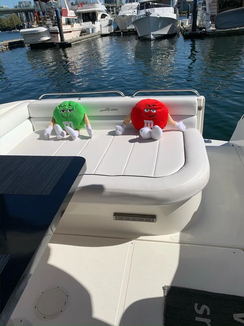 Slide: The Image of 1996 Wellcraft 45 Excalibur boat with plush toys on deck, docked at marina. - 9