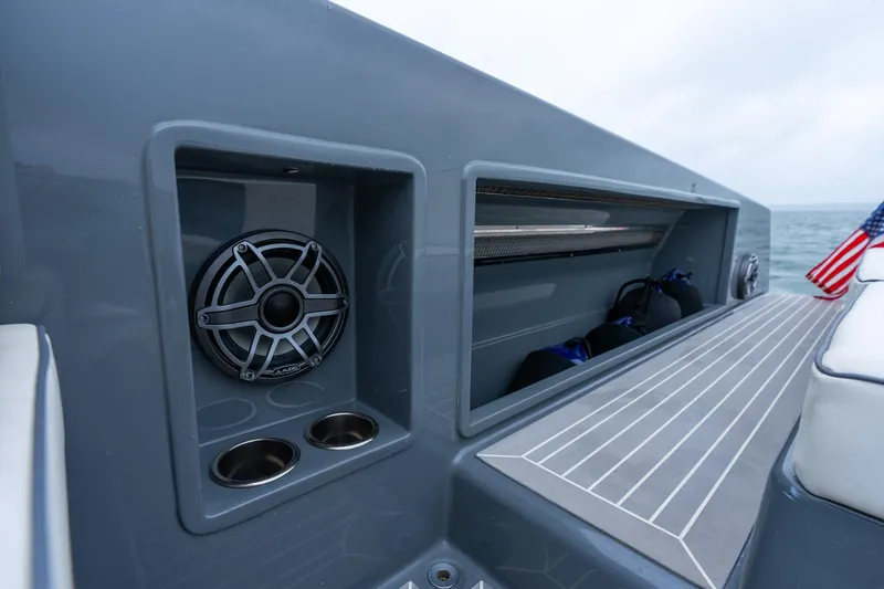 Slide: The Image of 2023 VanDutch 48 yacht interior with speaker and storage compartment. - 13