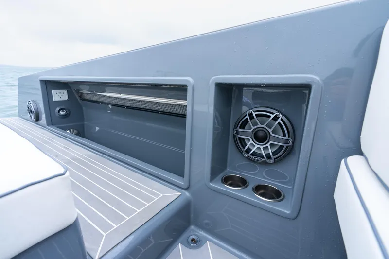 Slide: The Image of 2023 VanDutch 48 yacht interior with speaker and storage compartment. - 14