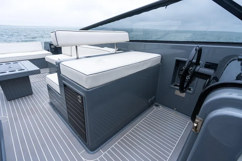 Slide: The Image of 2023 VanDutch 48 yacht interior with sleek seating and modern steering wheel design. - 19