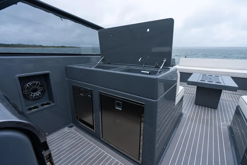 Slide: The Image of Luxury VanDutch 48 yacht interior with sleek kitchen area, ocean view, and modern design. - 22
