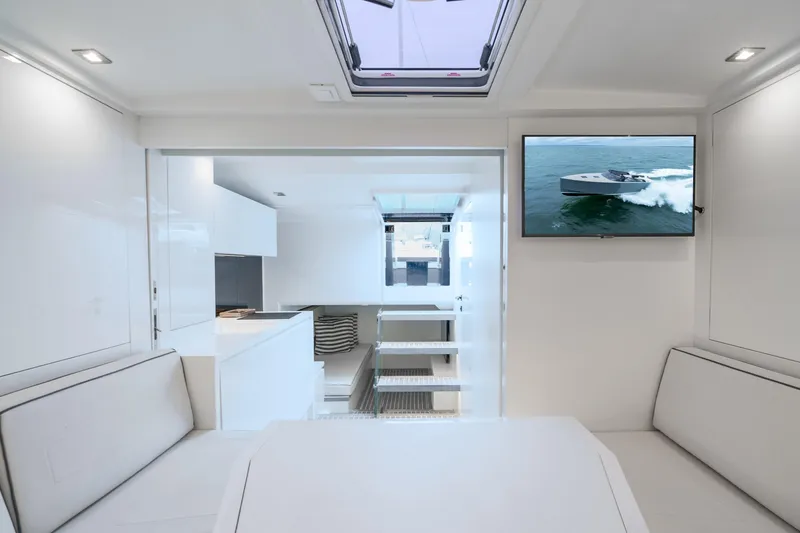 Slide: The Image of Interior of 2023 VanDutch 48 yacht, featuring modern design and a mounted TV screen. - 25