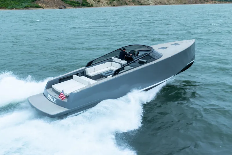 Slide: The Image of 2023 VanDutch 48 yacht cruising on open water, sleek design, luxury boating experience. - 4