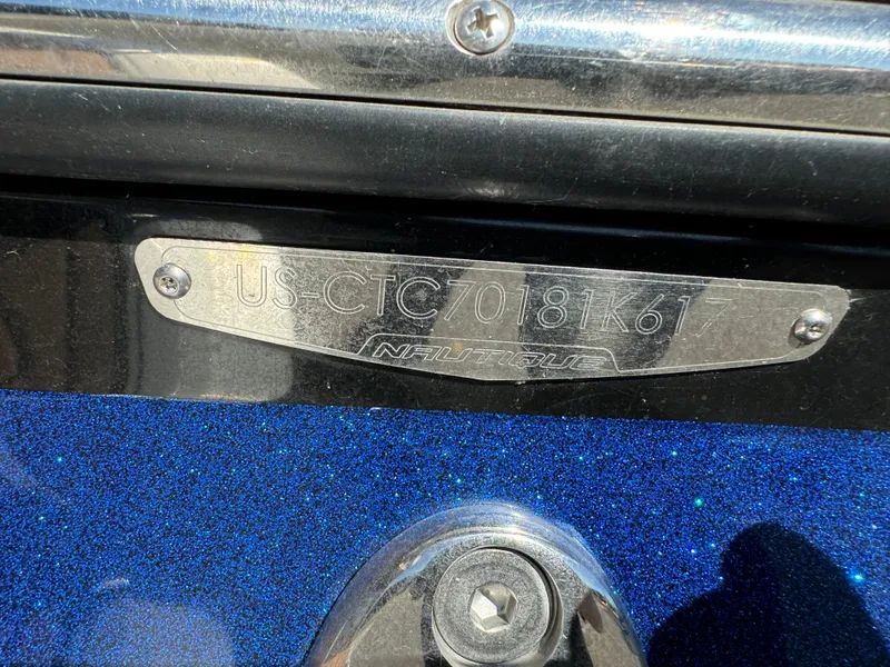 Slide: The Image of 2017 Nautique GS20 boat identification plate on blue metallic surface. - 11