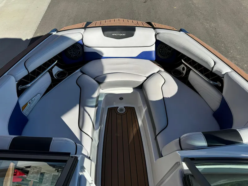 Slide: The Image of Interior of a 2017 Nautique GS20 boat with cushioned seating and wood accents. - 7