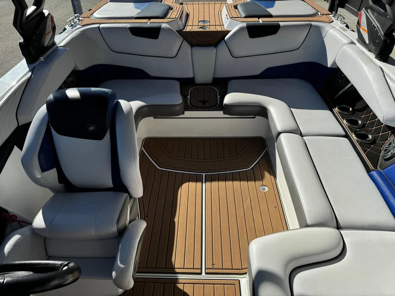 Slide: The Image of 2017 Nautique GS20 boat interior with luxurious seating and teak flooring. - 8