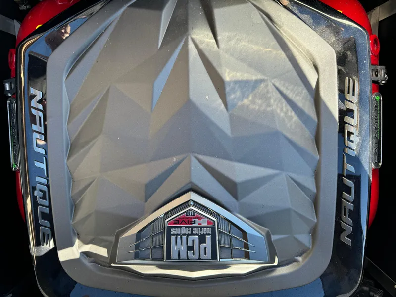 Slide: The Image of 2017 Nautique GS20 engine cover with PCM logo, featuring geometric design. - 9