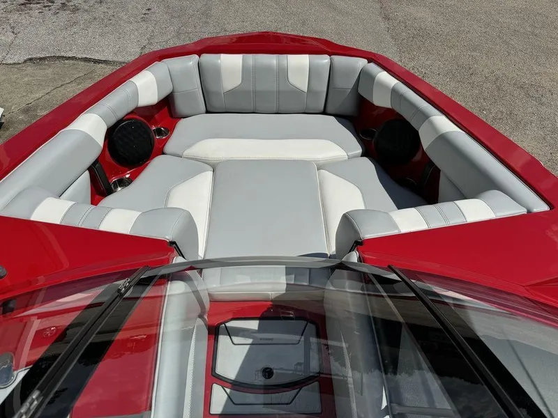 Slide: The Image of 2022 Malibu 21 LX boat interior with red and white seating. - 10