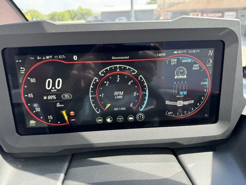 Slide: The Image of 2022 Malibu 21 LX dashboard display showing speed, RPM, and surf settings. - 13