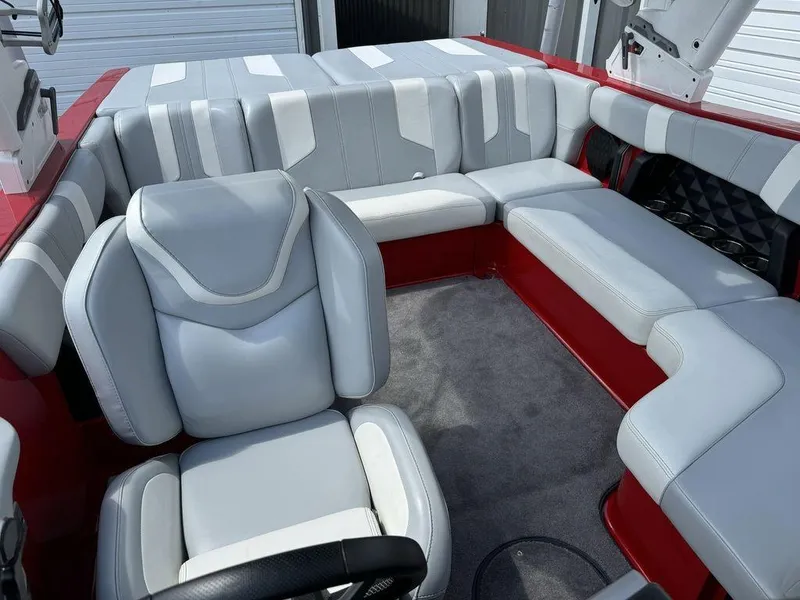 Slide: The Image of 2022 Malibu 21 LX boat interior with gray and red seating, modern design. - 15