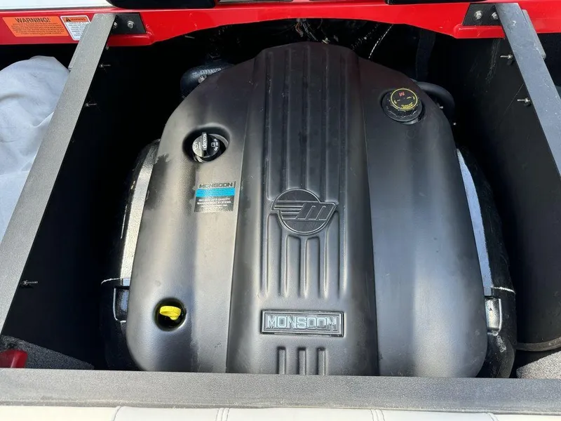 Slide: The Image of 2022 Malibu 21 LX Monsoon engine in boat compartment. - 16