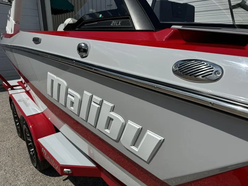 Slide: The Image of 2022 Malibu 21 LX boat with red and white exterior detailing. - 3
