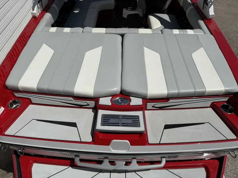 Slide: The Image of 2022 Malibu 21 LX boat interior with red and gray seating, sleek design. - 6