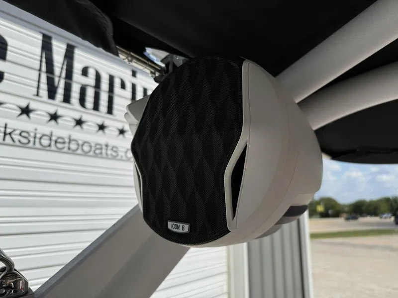 Slide: The Image of 2022 Malibu 21 LX boat speaker, Icon 8, mounted near marina. - 9