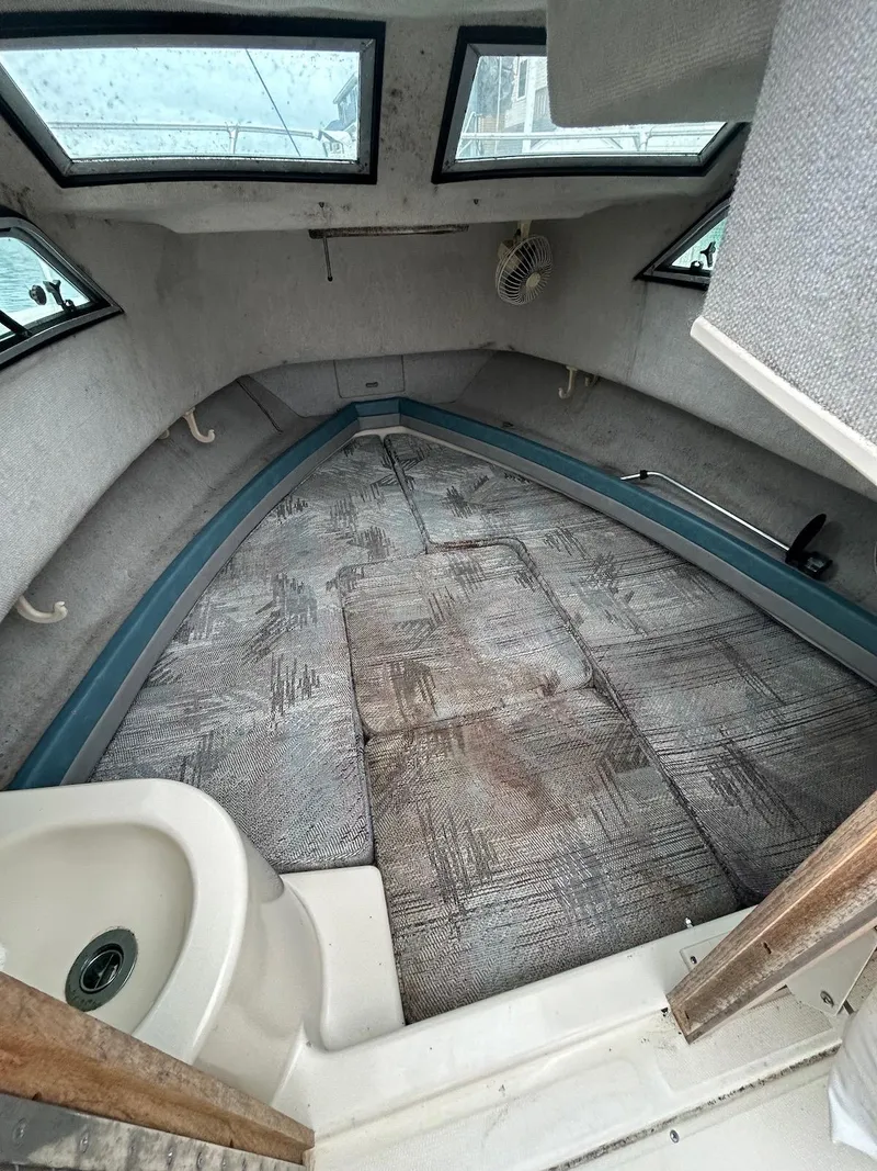 Slide: The Image of 1993 Grady-White 24 Explorer cabin interior with windows and seating area. - 10