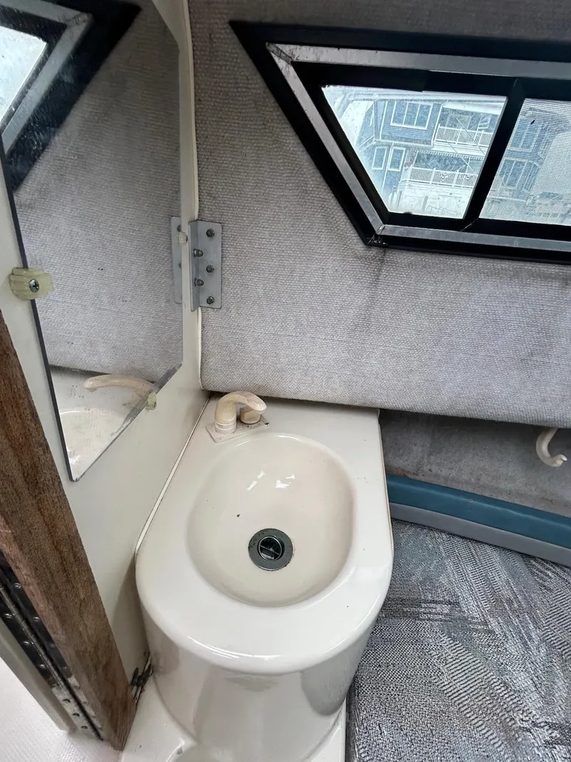 Slide: The Image of 1993 Grady-White 24 Explorer boat interior with sink and window. - 11