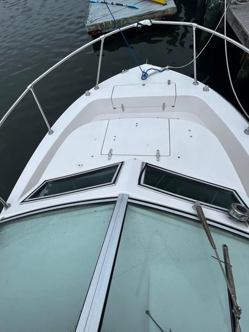 Slide: The Image of 1993 Grady-White 24 Explorer boat docked, showing bow and windshield. - 19