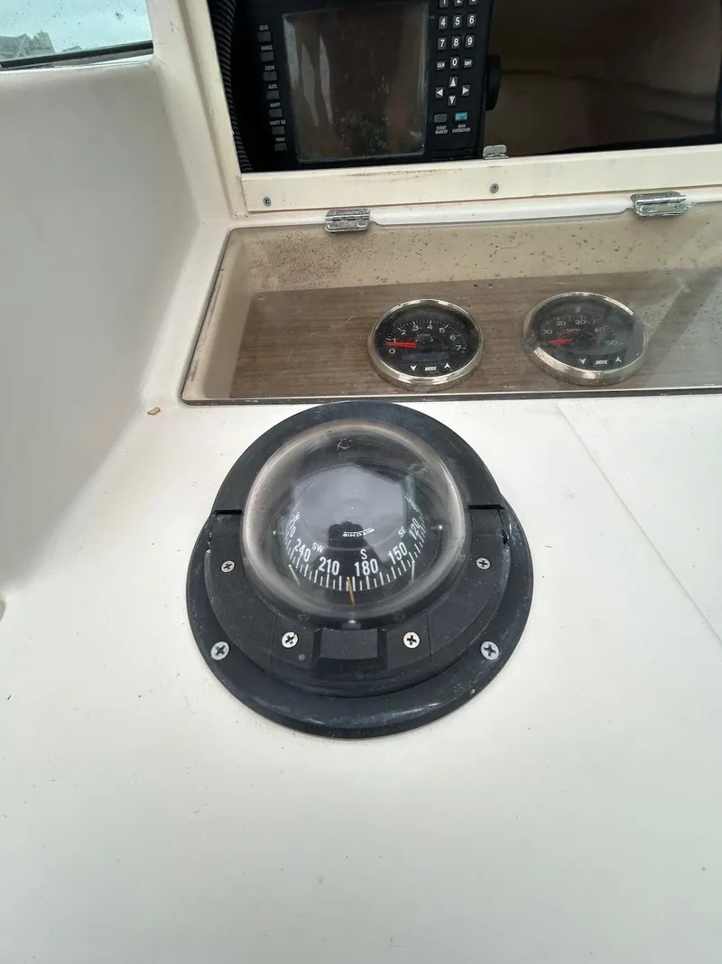 Slide: The Image of Compass and gauges on 1993 Grady-White 24 Explorer boat dashboard. - 24