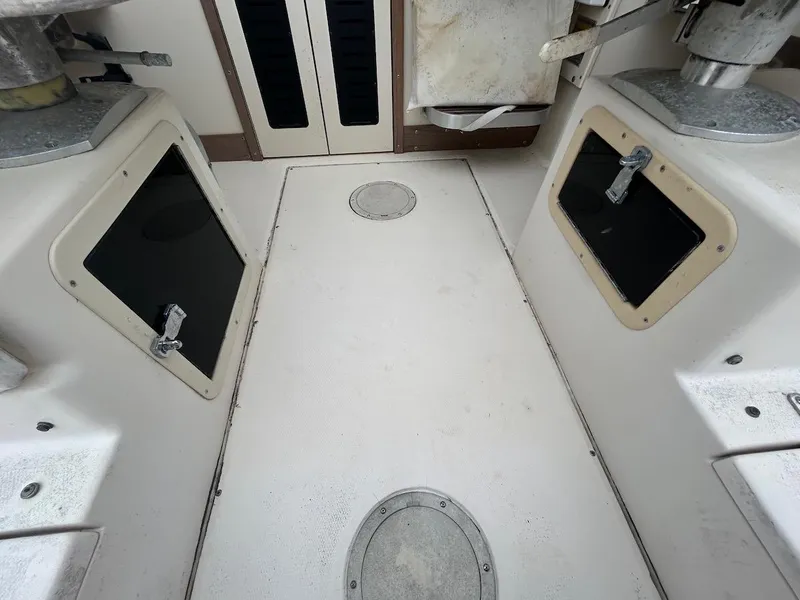 Slide: The Image of 1993 Grady-White 24 Explorer boat interior with storage compartments and clean deck. - 28