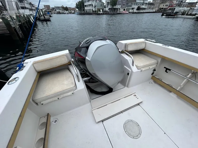 Slide: The Image of 1993 Grady-White 24 Explorer boat interior with motor, docked in a marina. - 3