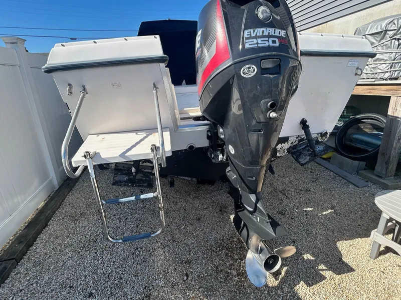 Slide: The Image of 1993 Grady-White 24 Explorer boat with Evinrude 250 outboard motor, parked on gravel. - 32