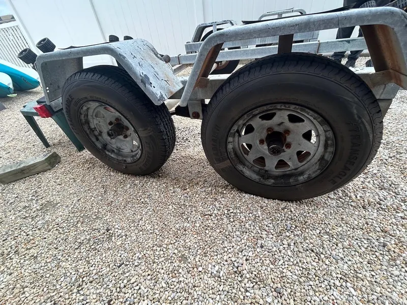Slide: The Image of Trailer wheels on gravel for 1993 Grady-White 24 Explorer boat. - 38