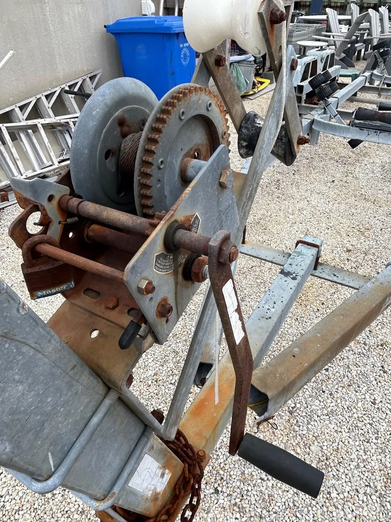 Slide: The Image of Rusty boat trailer winch for 1993 Grady-White 24 Explorer on gravel surface. - 39