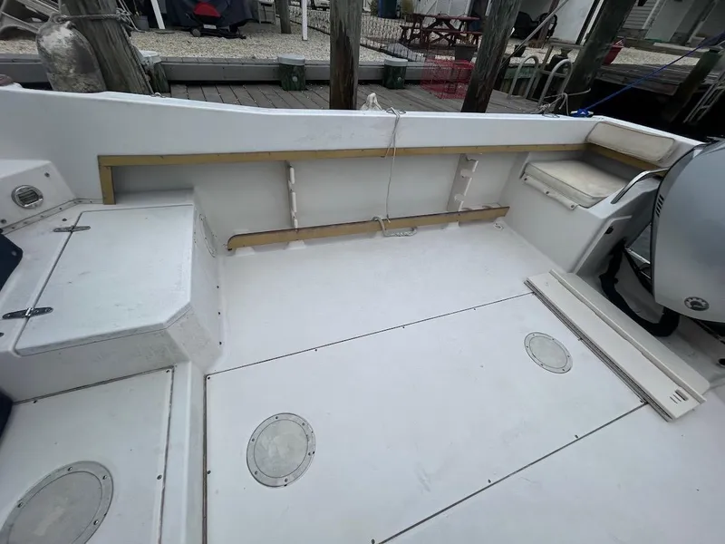 Slide: The Image of 1993 Grady-White 24 Explorer boat deck with seating and storage compartments. - 5