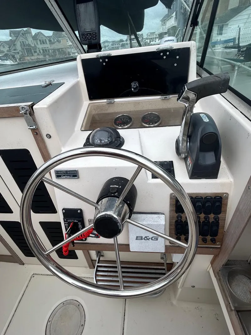 Slide: The Image of 1993 Grady-White 24 Explorer boat helm with steering wheel and control panel. - 9