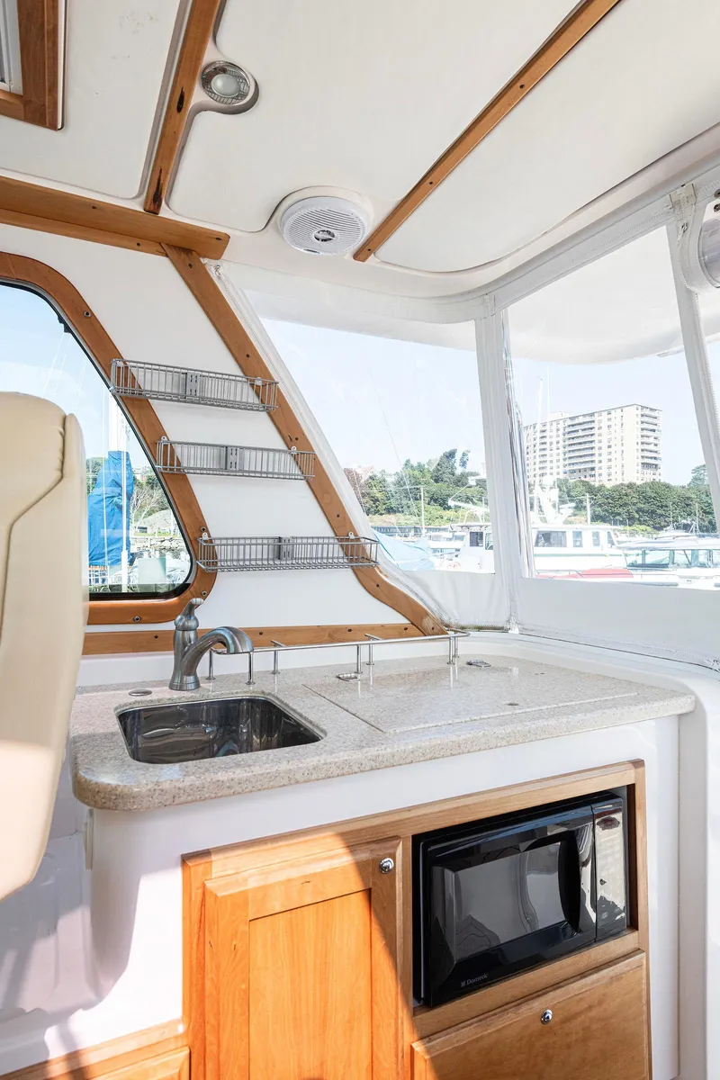 Slide: The Image of 2008 Sabre 34 Express boat interior with kitchenette, sink, and microwave. - 10