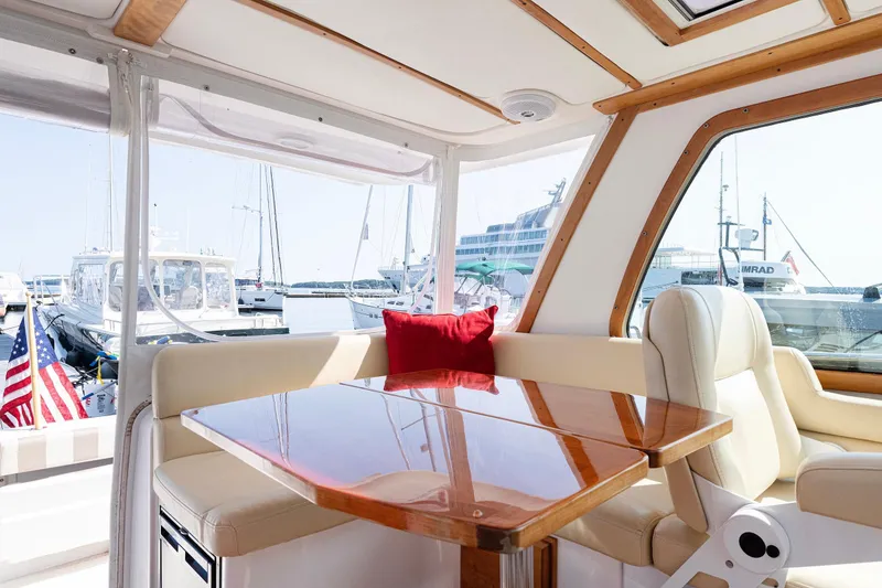 Slide: The Image of Interior of 2008 Sabre 34 Express yacht with wooden table and cream seating. - 11