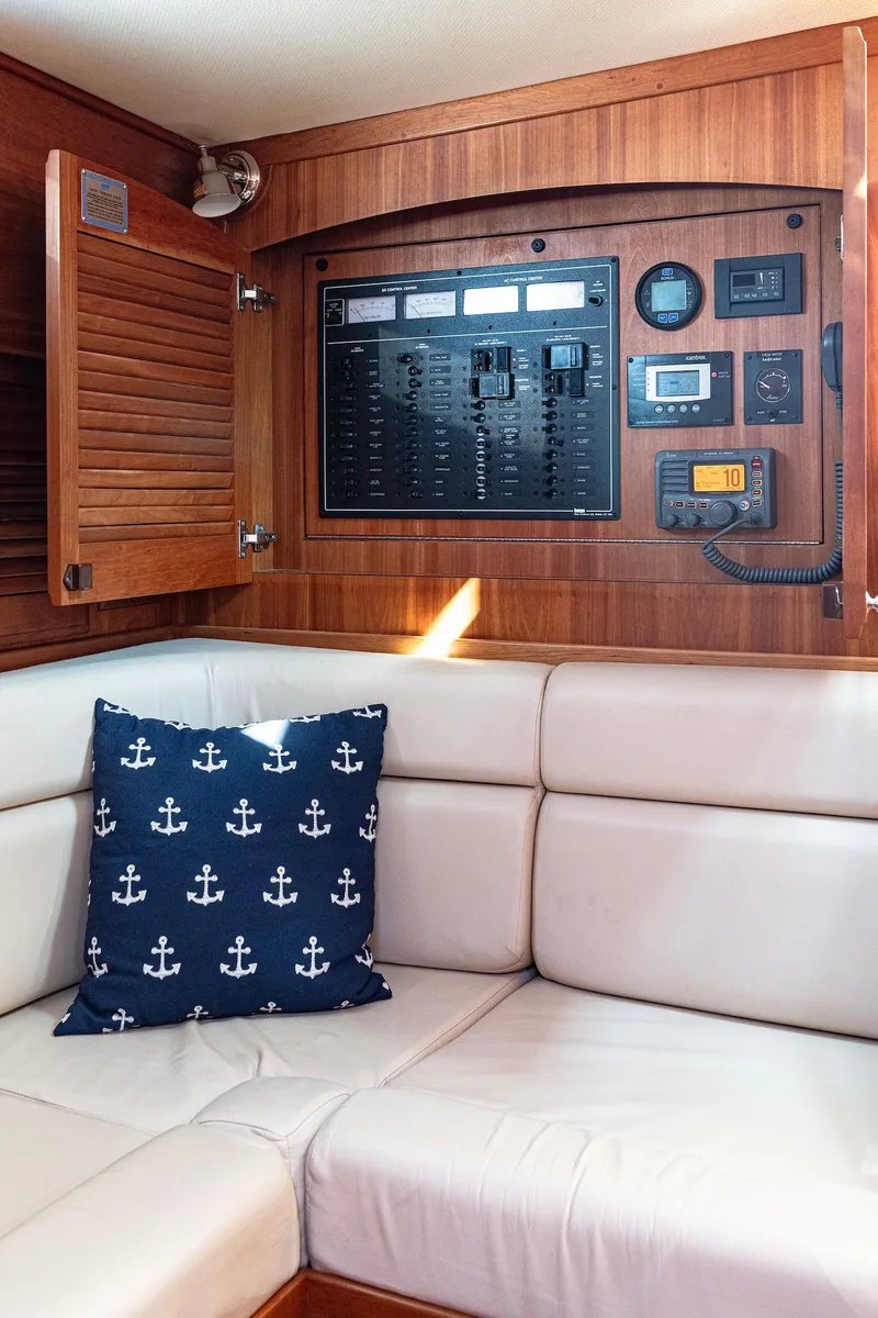 Slide: The Image of Interior of 2008 Sabre 34 Express yacht with control panel and anchor-themed pillow. - 15