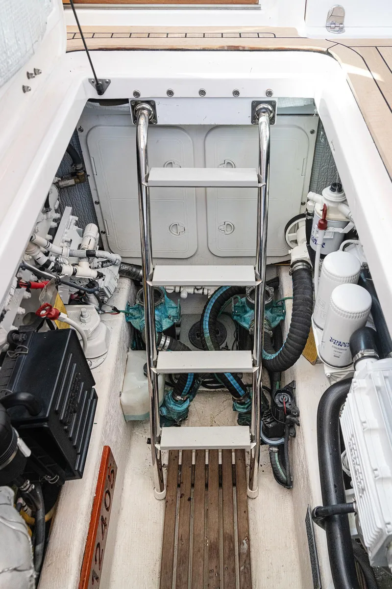 Slide: The Image of Engine compartment of 2008 Sabre 34 Express boat with ladder and mechanical components. - 23