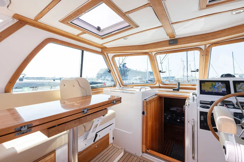 Slide: The Image of Interior of 2008 Sabre 34 Express yacht with wood accents and navigation equipment. - 8