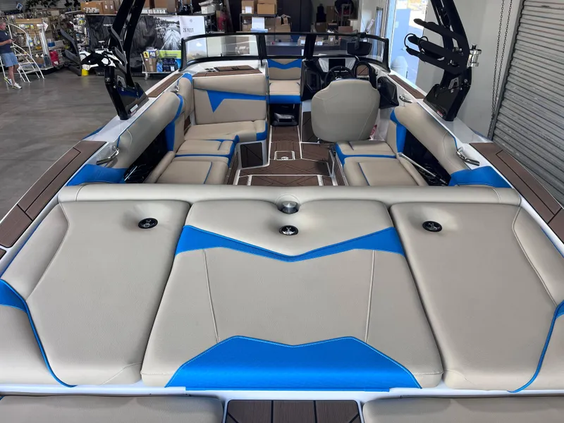 Slide: The Image of 2025 Supreme S240 boat interior with beige and blue seating, modern design. - 3