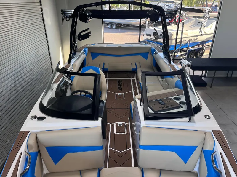 Slide: The Image of 2025 Supreme S240 boat interior with blue and white seating, sleek design, and modern features. - 4