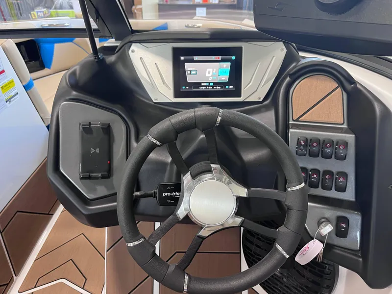 Slide: The Image of 2025 Supreme S240 boat dashboard with steering wheel and digital display. - 6