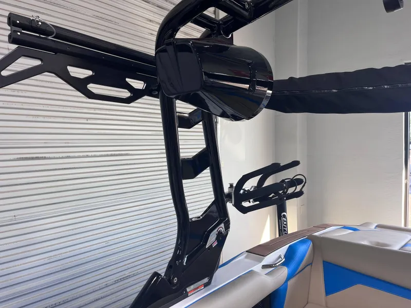 Slide: The Image of 2025 Supreme S240 boat interior with sleek black tower and blue-accented seating. - 9