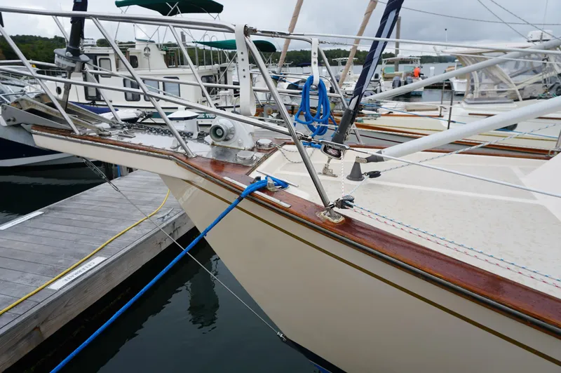 Slide: The Image of 1994 Island Packet 32 sailboat docked at marina, featuring detailed bow and deck. - 11