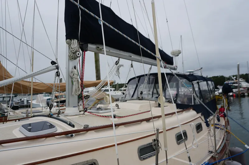 Slide: The Image of 1994 Island Packet 32 sailboat docked at marina, featuring classic design and rigging. - 12