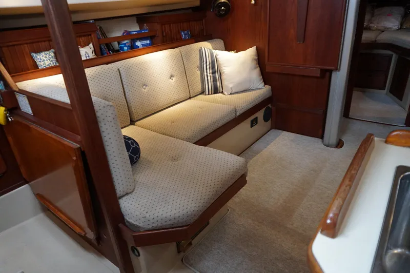 Slide: The Image of 1994 Island Packet 32 interior with cozy seating and wooden accents. - 16