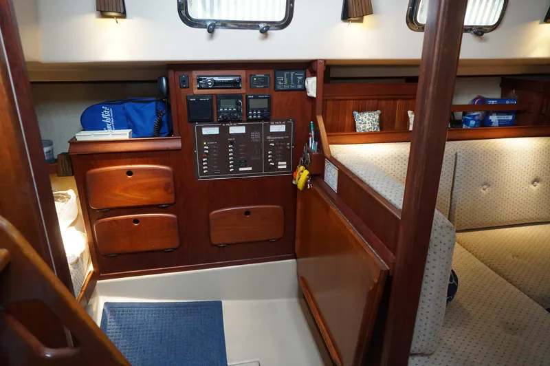 Slide: The Image of 1994 Island Packet 32 sailboat interior with control panel and wooden cabinetry. - 17