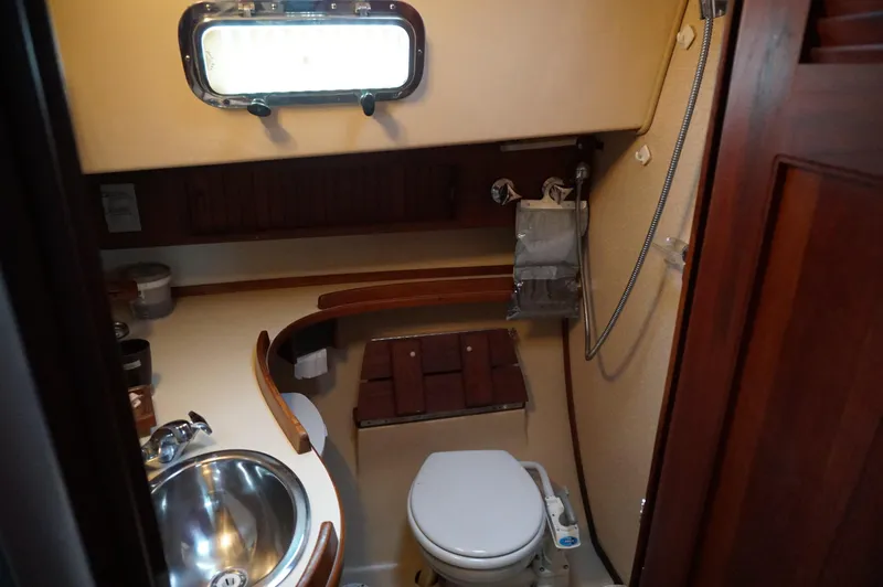 Slide: The Image of 1994 Island Packet 32 yacht bathroom with sink, toilet, and shower. - 20