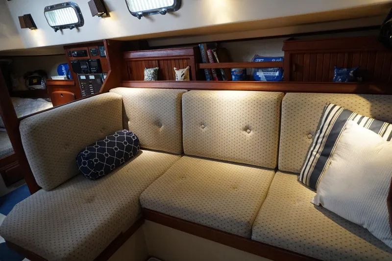 Slide: The Image of Interior of 1994 Island Packet 32 sailboat with cozy seating and nautical decor. - 26