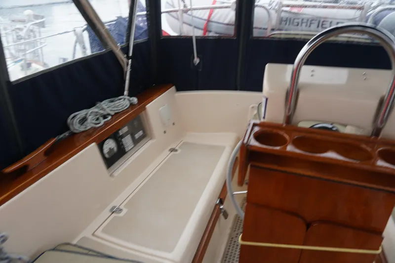 Slide: The Image of 1994 Island Packet 32 sailboat cockpit with seating, helm, and navigation instruments. - 35