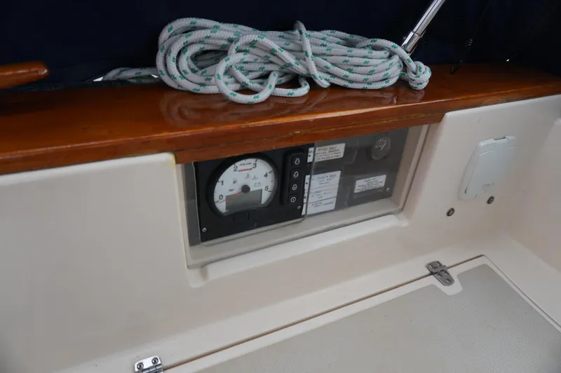 Slide: The Image of 1994 Island Packet 32 sailboat cockpit with control panel and coiled rope. - 36