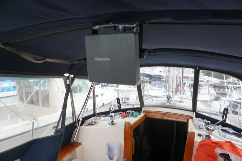 Slide: The Image of Interior view of a 1994 Island Packet 32 sailboat cockpit with navigation equipment. - 39