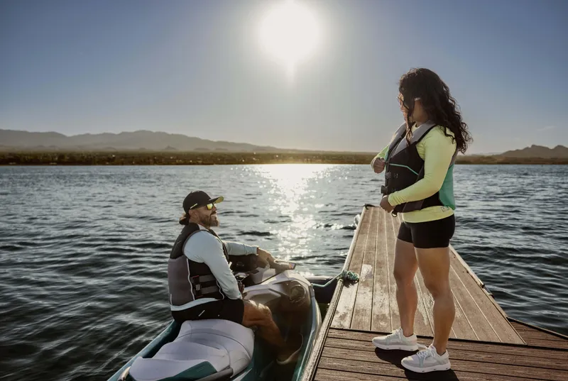 Slide: The Image of Two people enjoying a sunny day with a 2025 Sea-Doo GTX Limited 325 on a dock. - 10