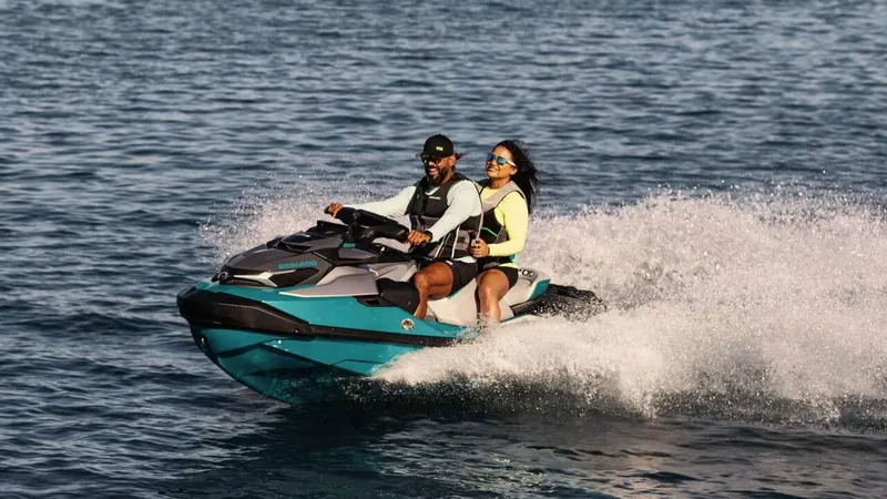 Slide: The Image of 2025 Sea-Doo GTX Limited 325 with Sound, two people riding on open water. - 4