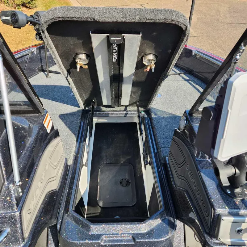 Slide: The Image of 2024 Nitro ZV20 Pro boat storage compartment open, showcasing interior space. - 11